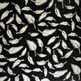 Toile paillette imperméable motifs feuilles noires